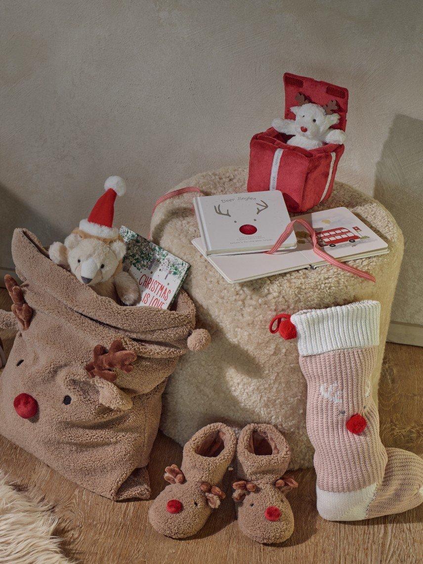 a room with a baby's room with toys and a christmas tree