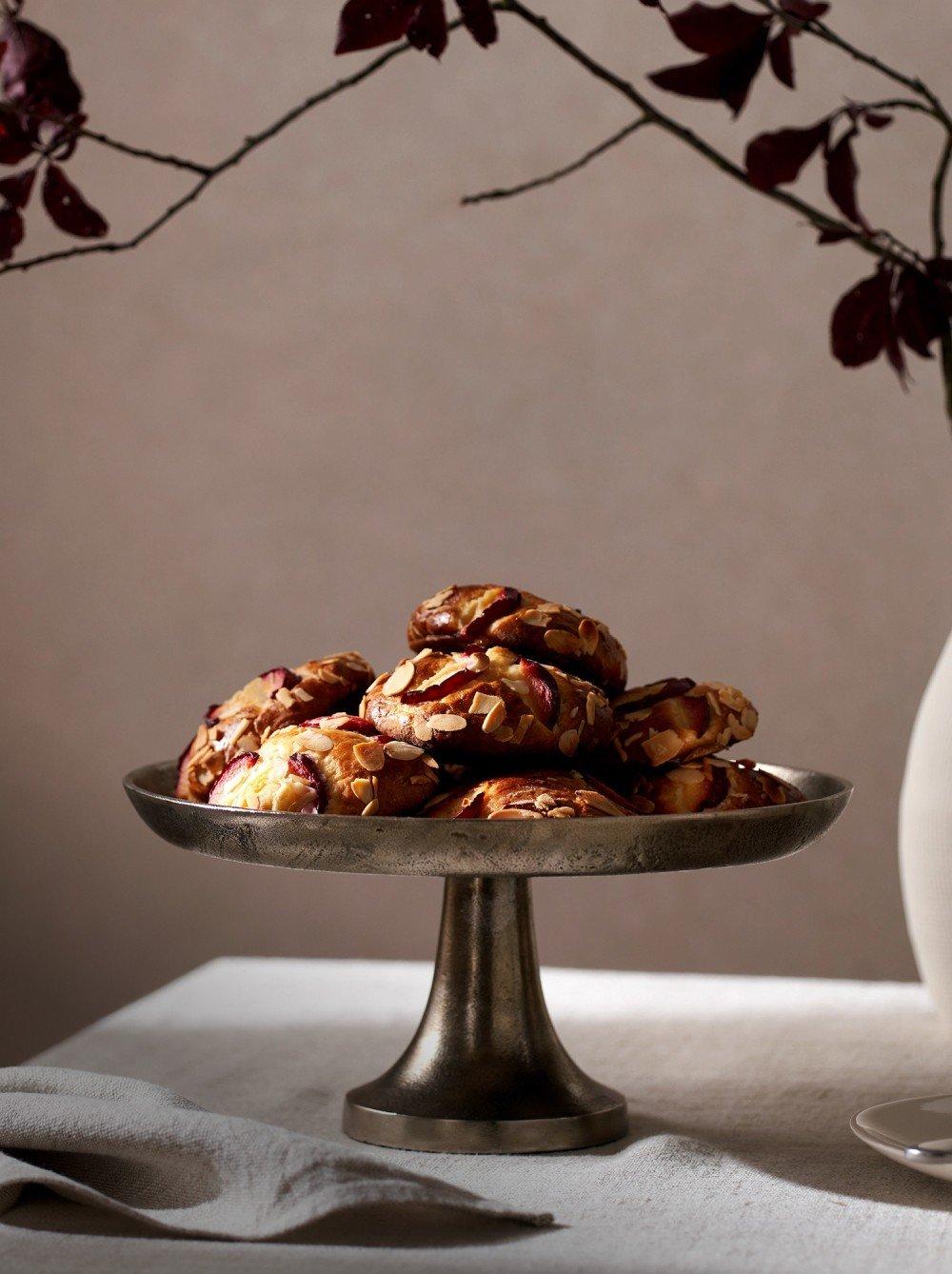 a plate of cookies on a silver platter on a table