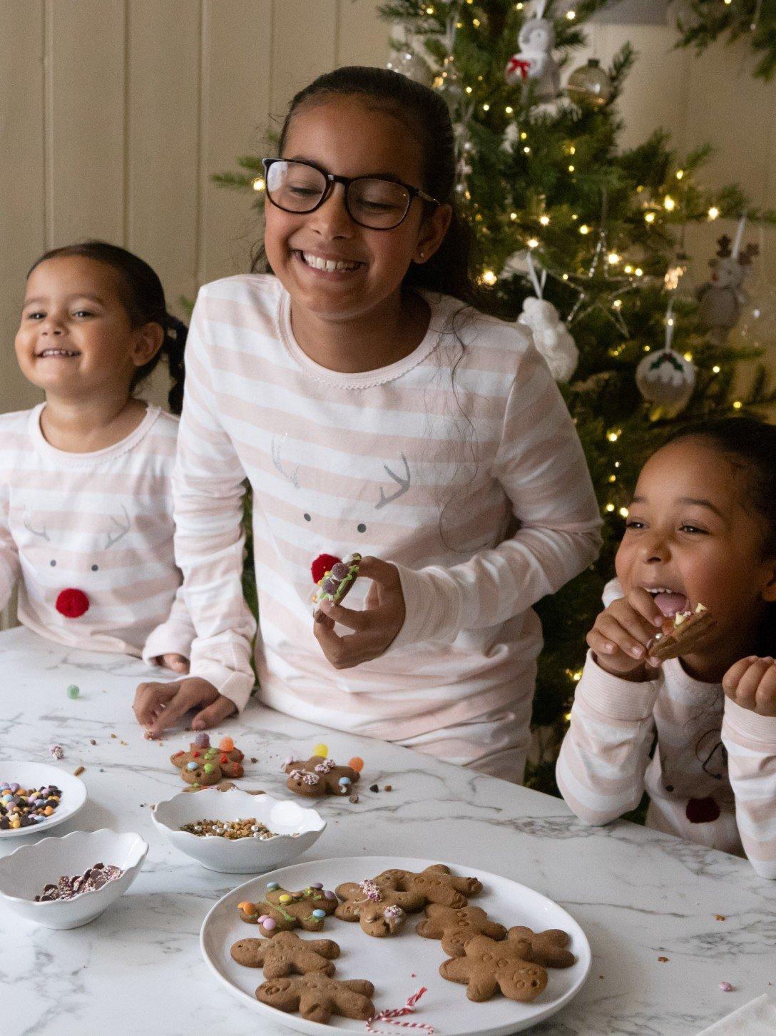 a group of children are eating cookies and drinking milk