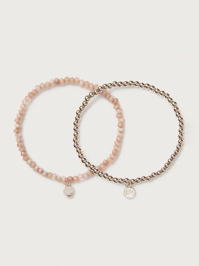 two bracelets with pink beads and a gold disc