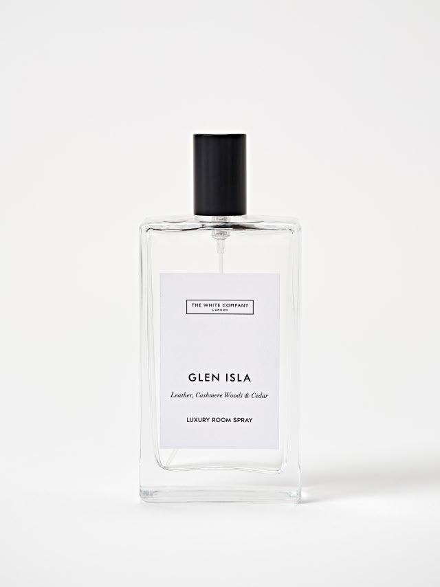 a bottle of perfume on a white surface