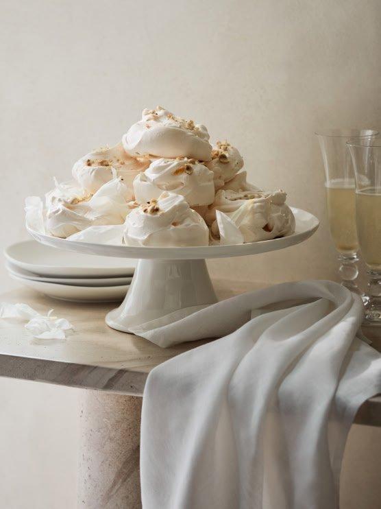 a white cake with meringue on top of a white plate