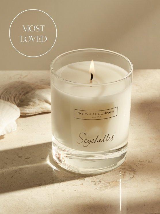 a candle with a label that says most loved