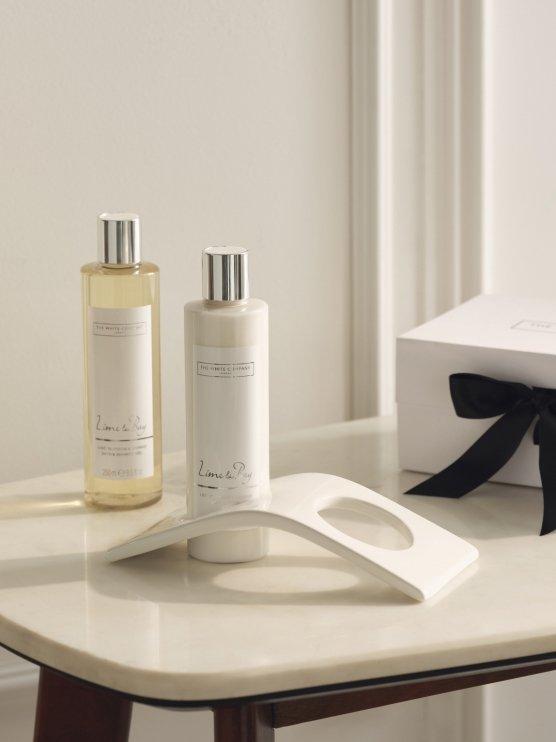 a white table with two bottles of lotion and a box of soap