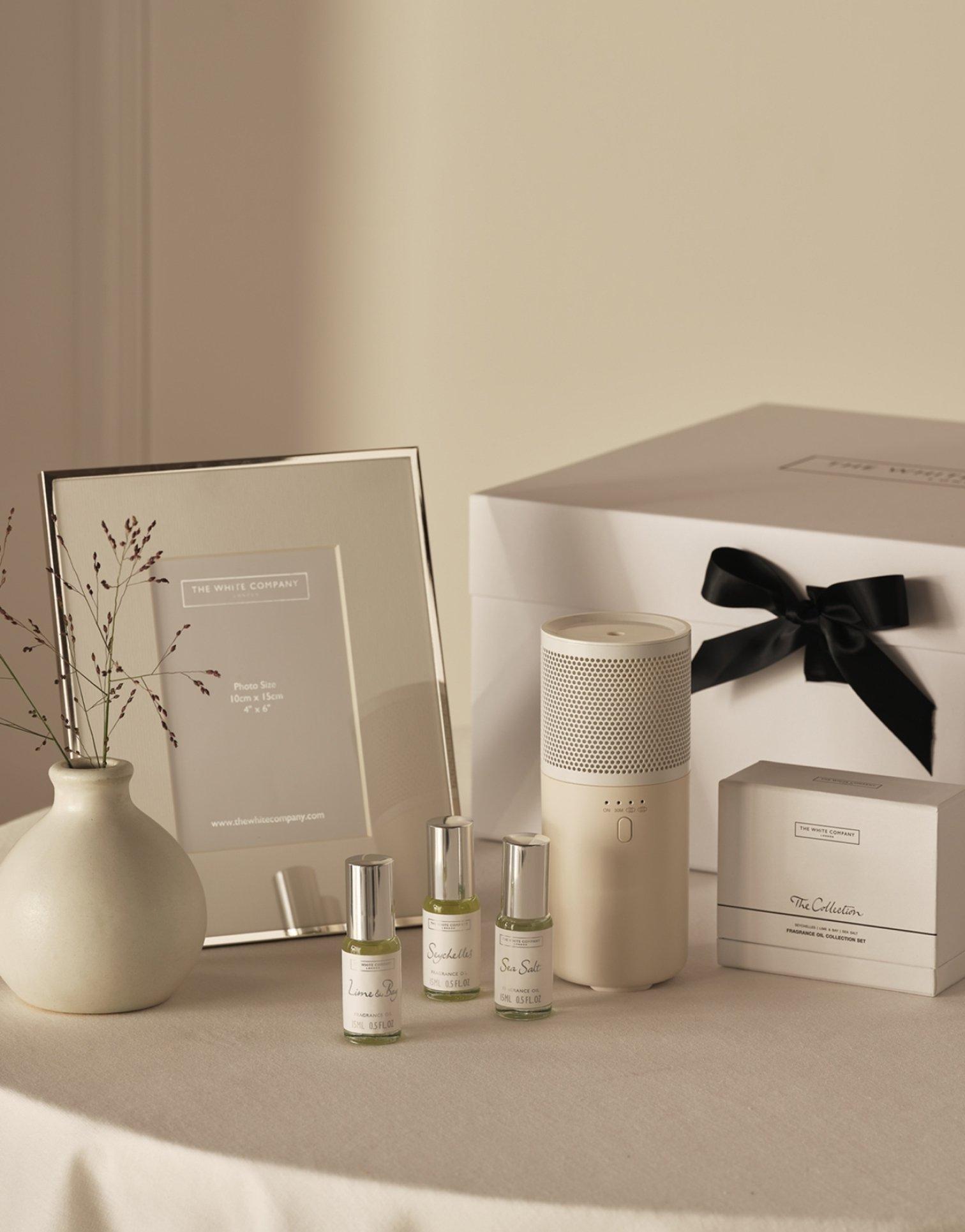 a table with a vase, a picture frame, and a box of items