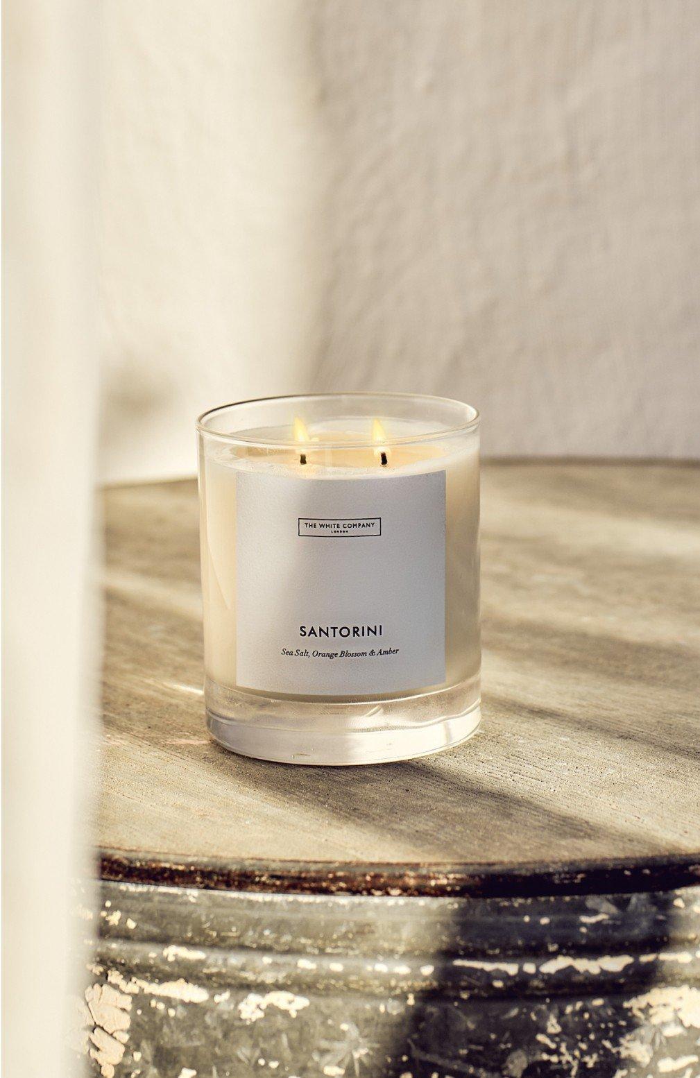 a candle sitting on top of a table on a wooden surface