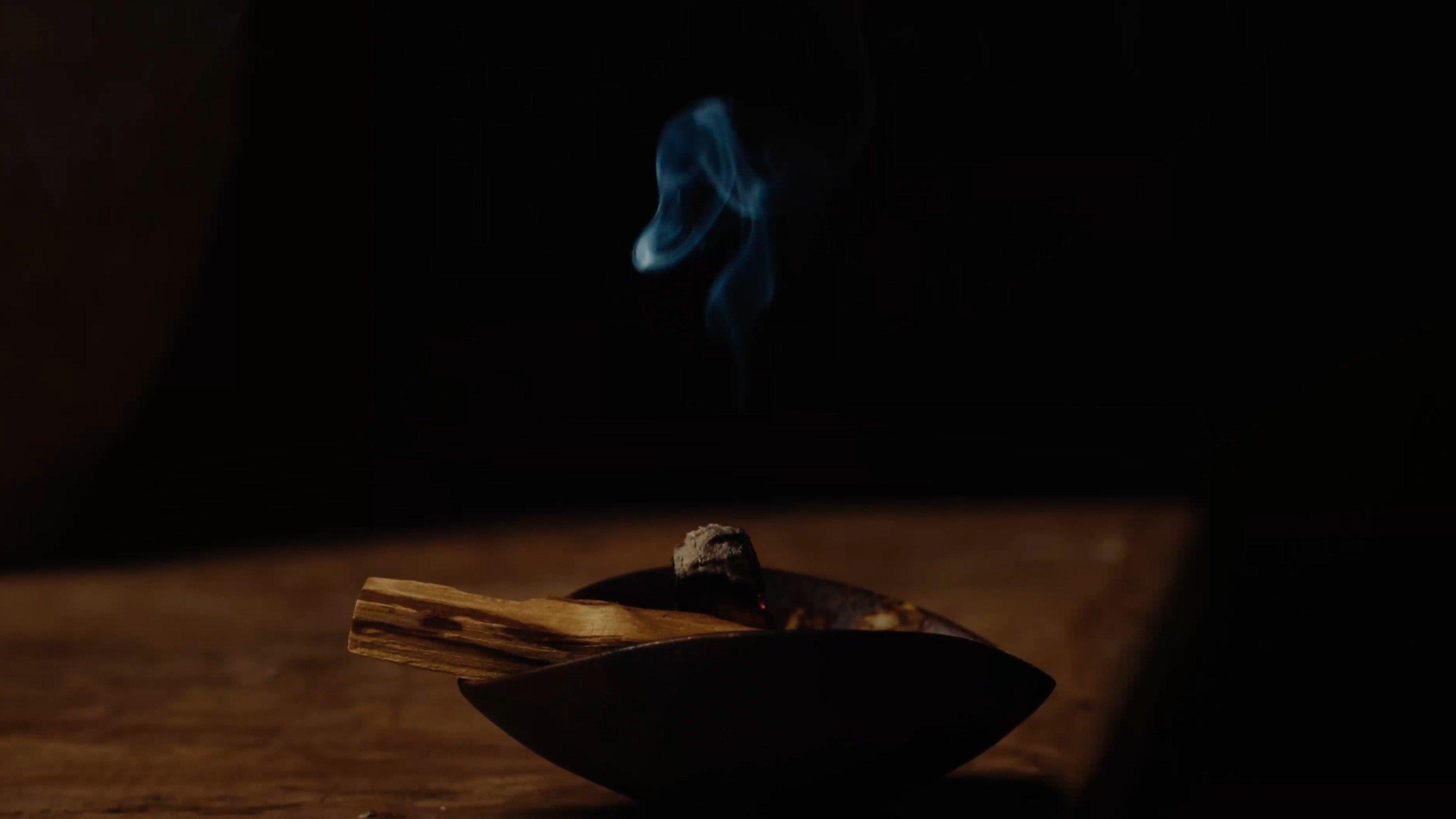 a small bowl with a candle and a small amount of smoke