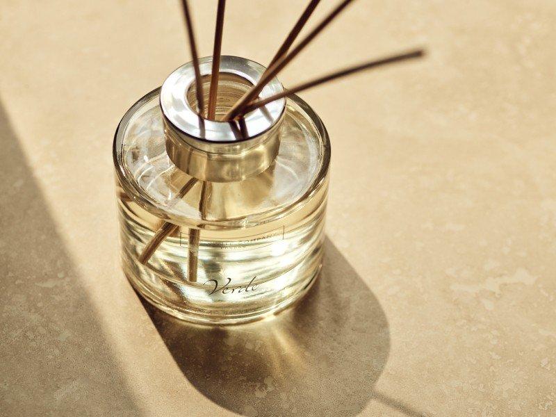 a close up of a bottle of perfume sitting on a table