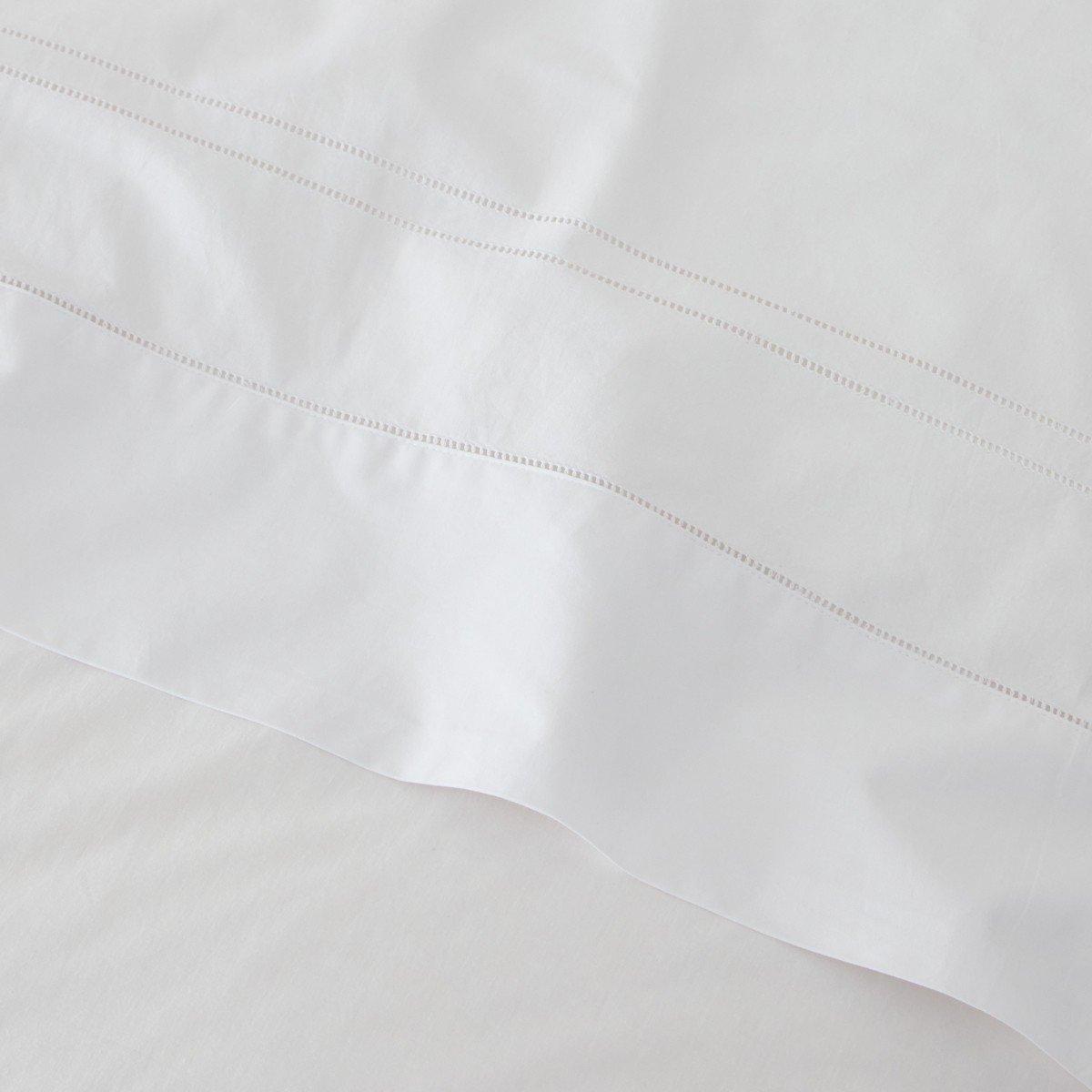 a close up of a white sheet with a white border