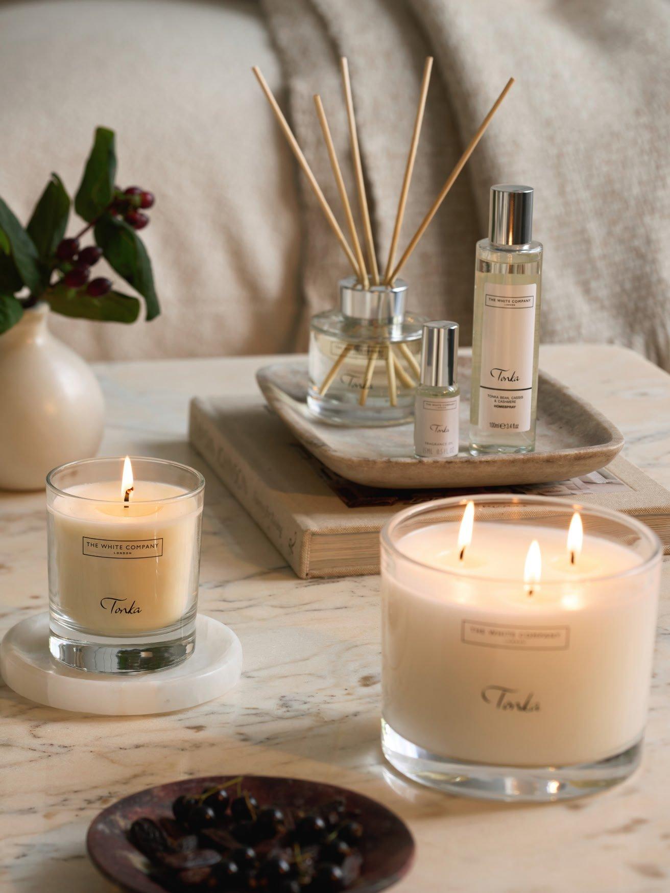 a table with candles and other items on it in a room