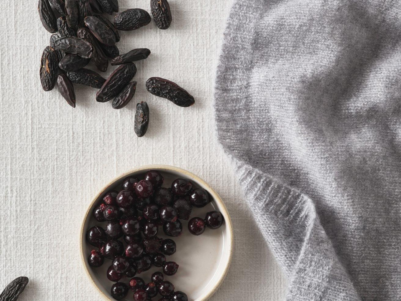 a bowl of dried fruit and a cloth with a bunch of seeds