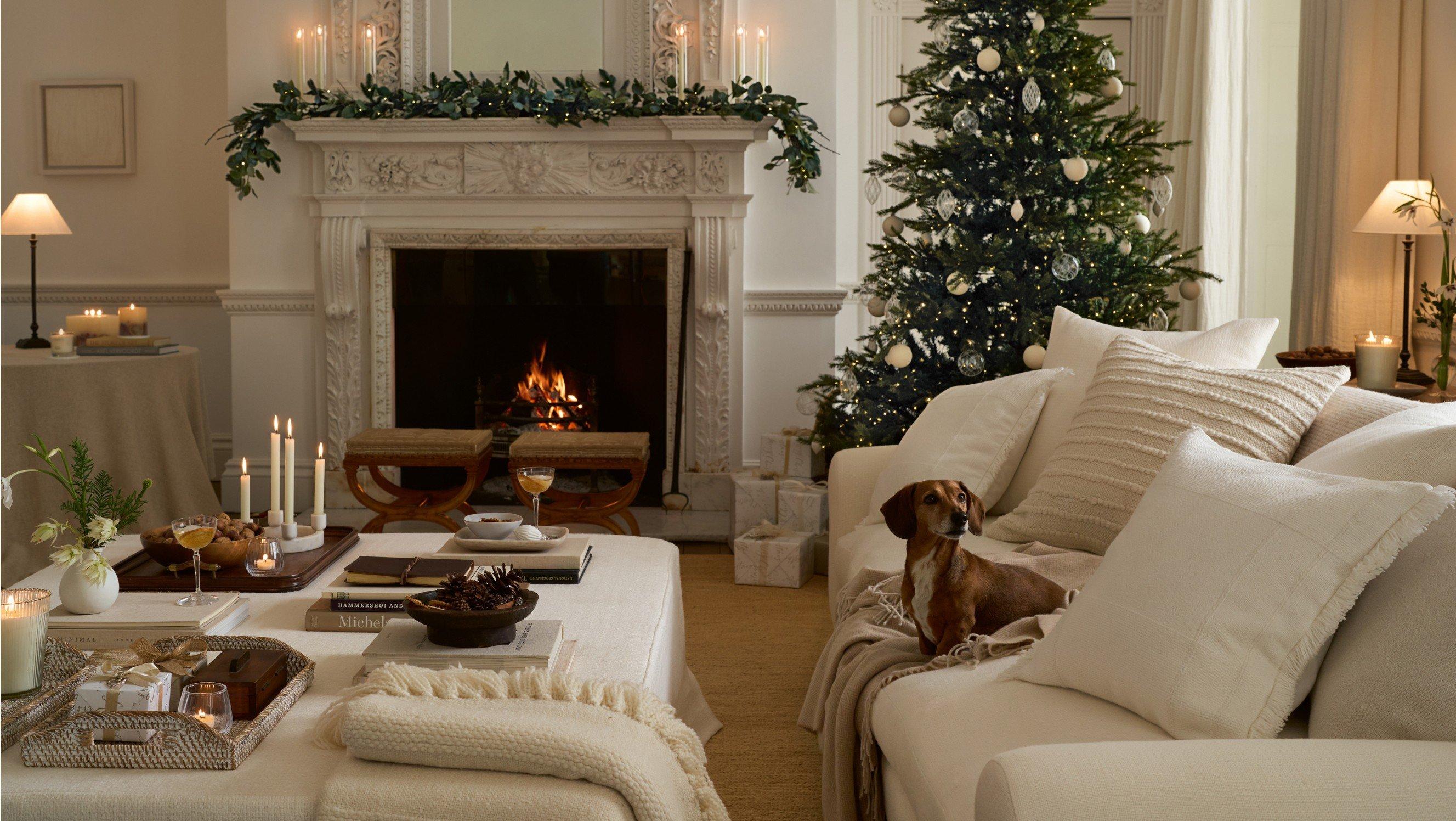 a living room with a fireplace and christmas tree in it
