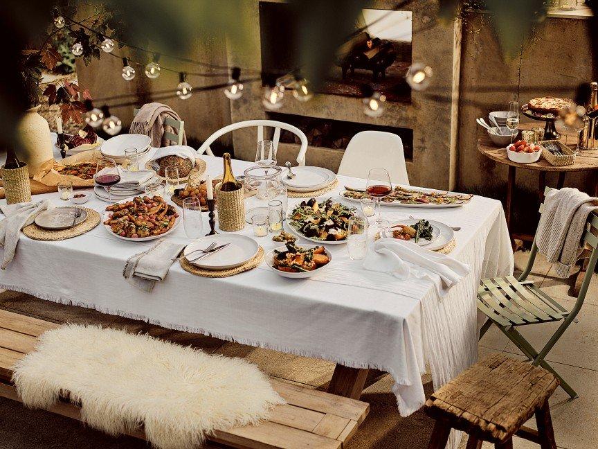 a table set with plates and bowls of food on it