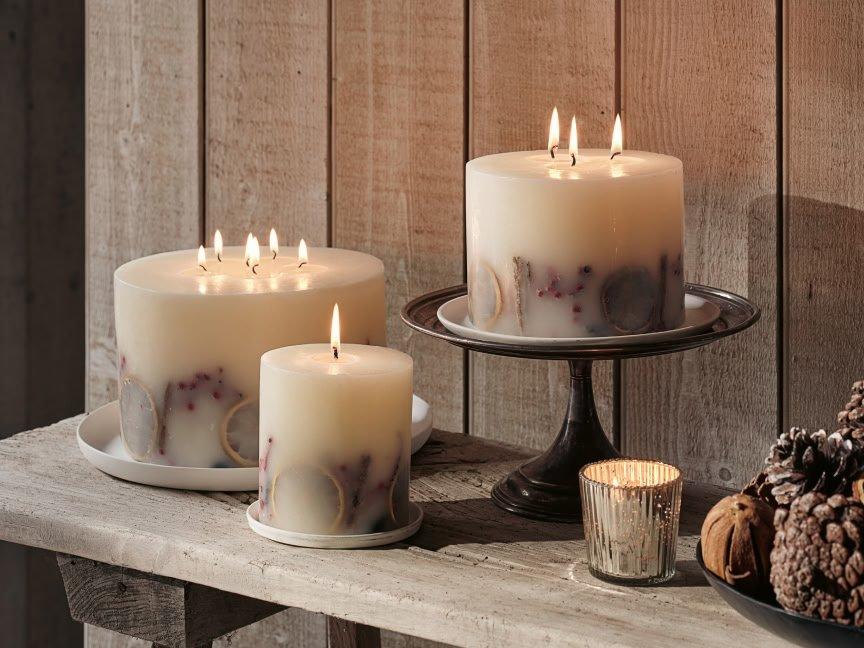 a table with candles and a bowl of nuts on it