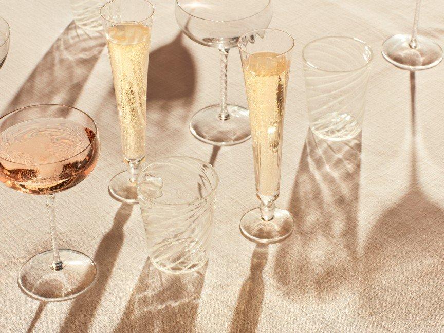 a table with several glasses of wine and champagne