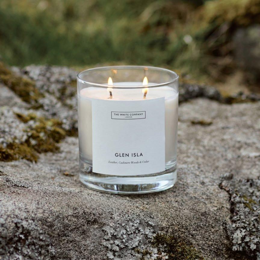 a candle sitting on a rock with a label that says glen isla