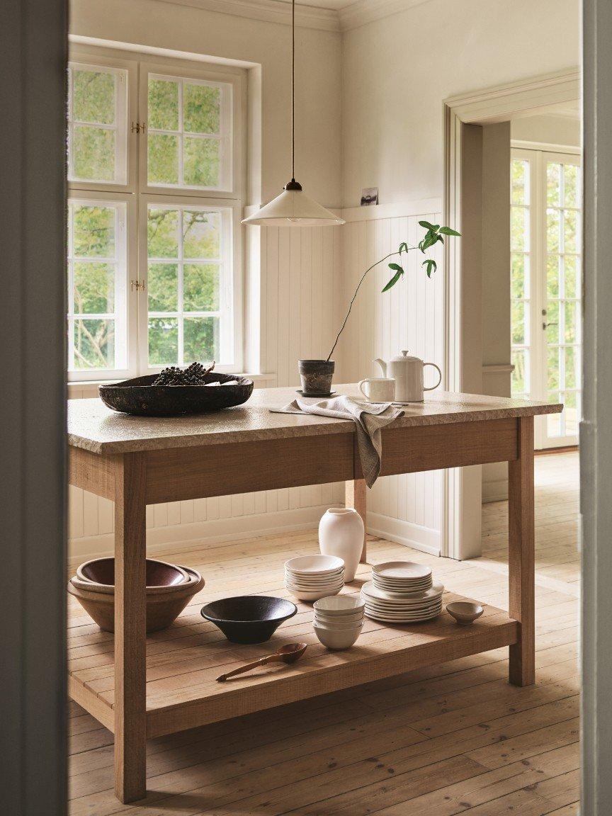 a kitchen with a table and bowls on it in a room