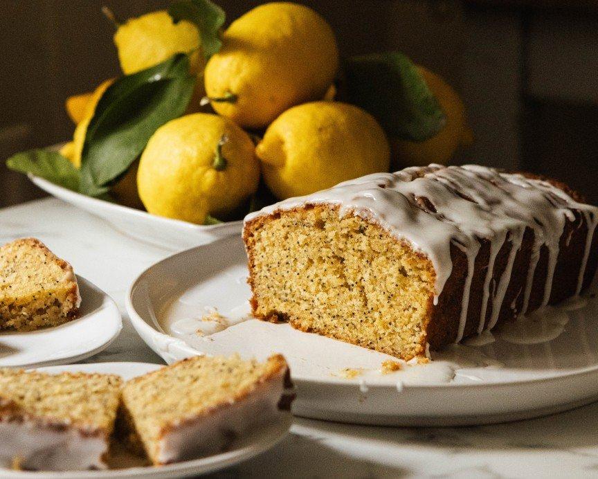 a loaf of cake on a plate with a slice cut out