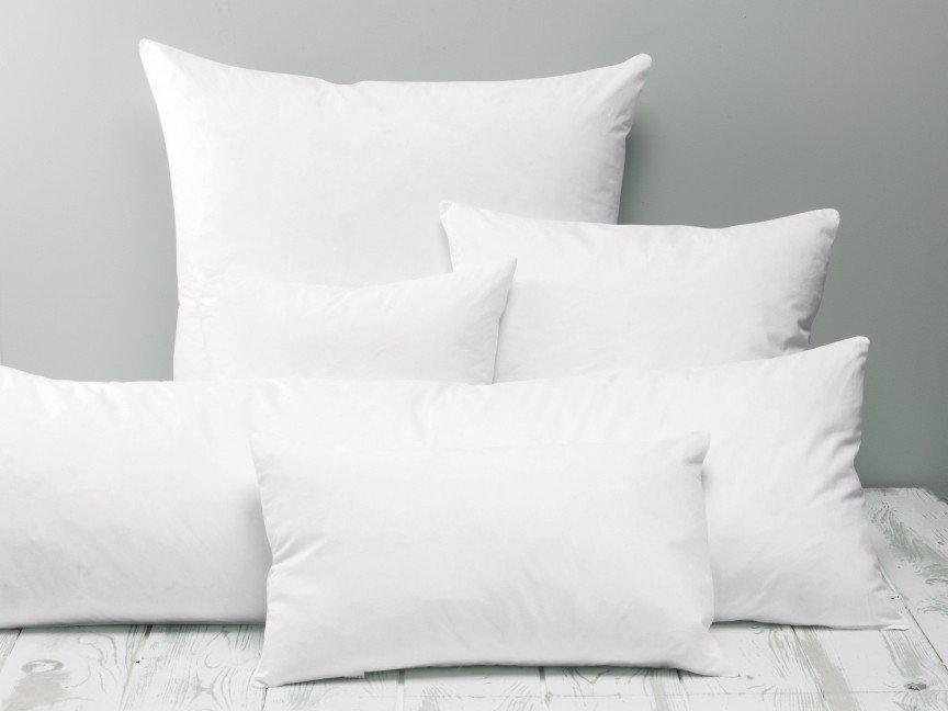 a group of white pillows sitting on top of a wooden table
