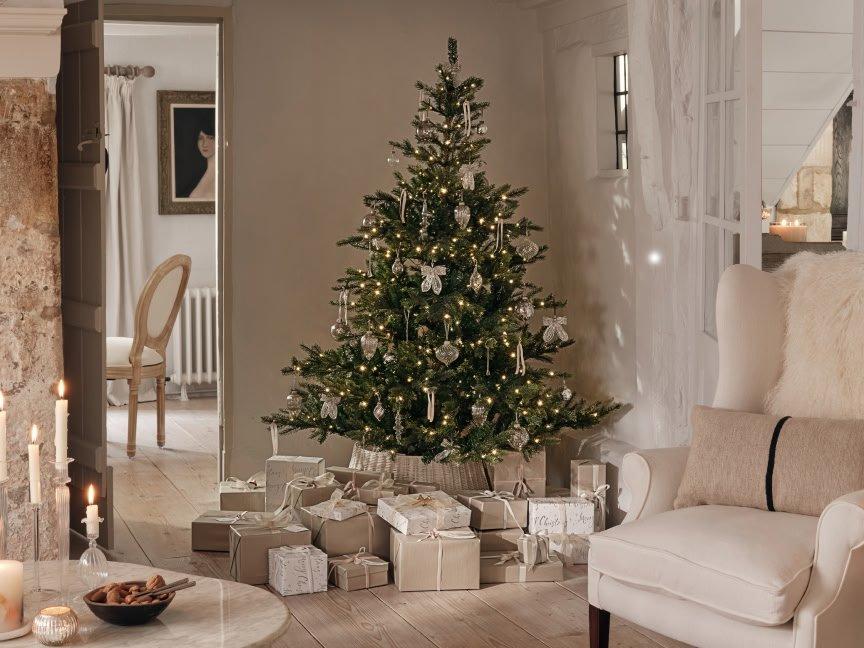 a living room with a christmas tree and presents under it