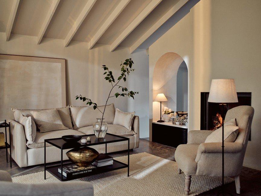 a living room with a fireplace and a couch and chairs