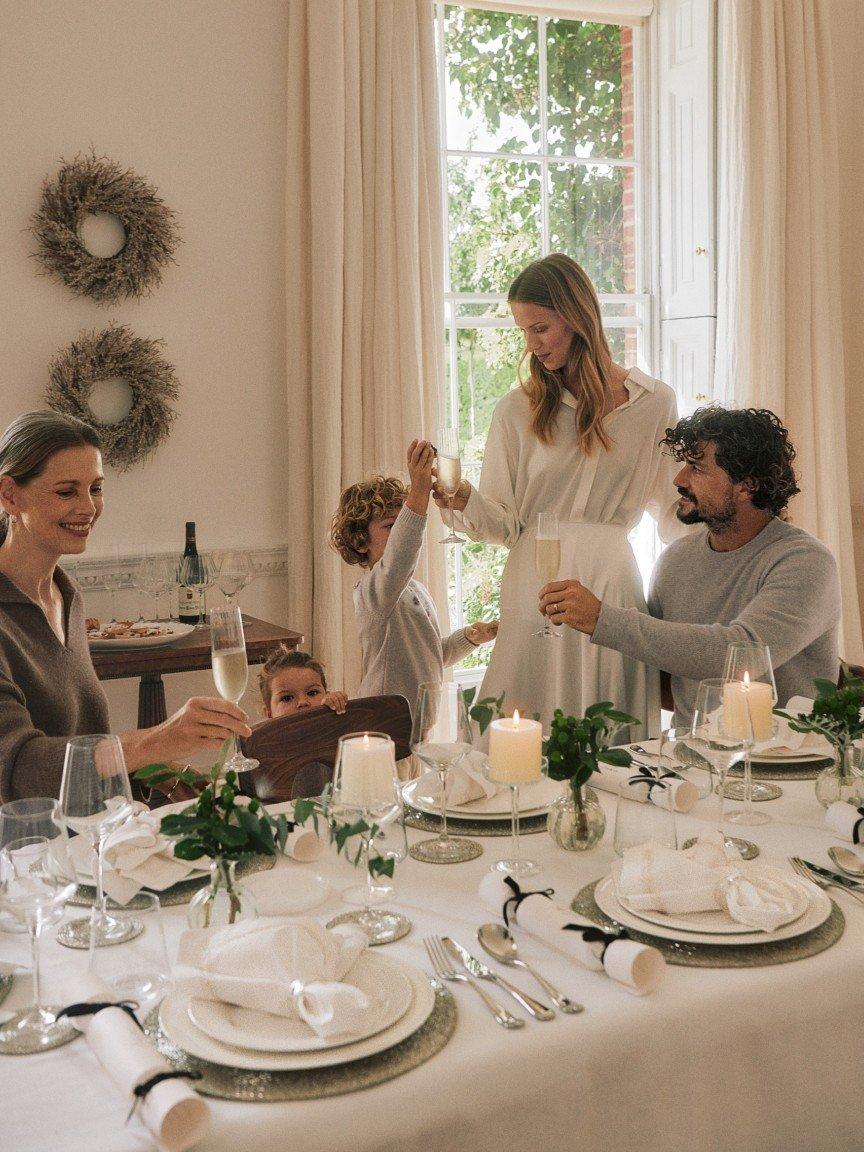 a little girl standing in front of a christmas tree with presents