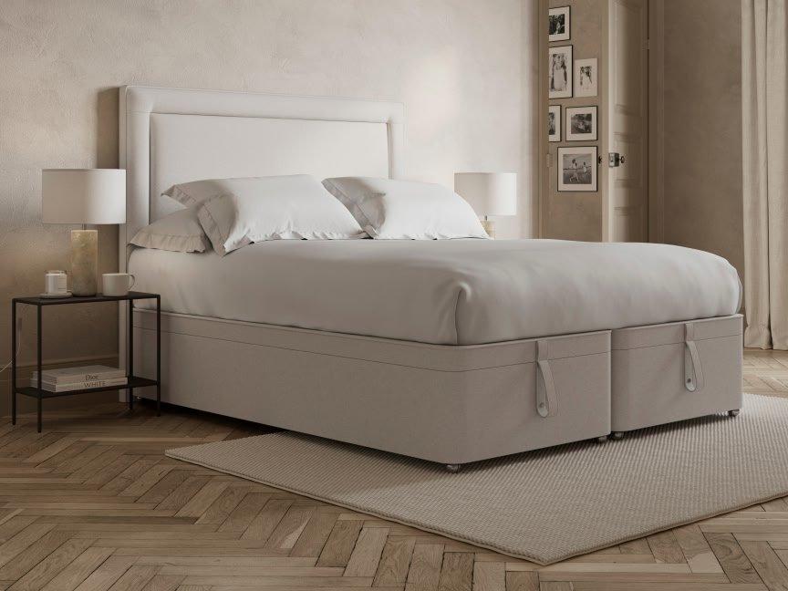 a bed with a white headboard and footboard in a bedroom