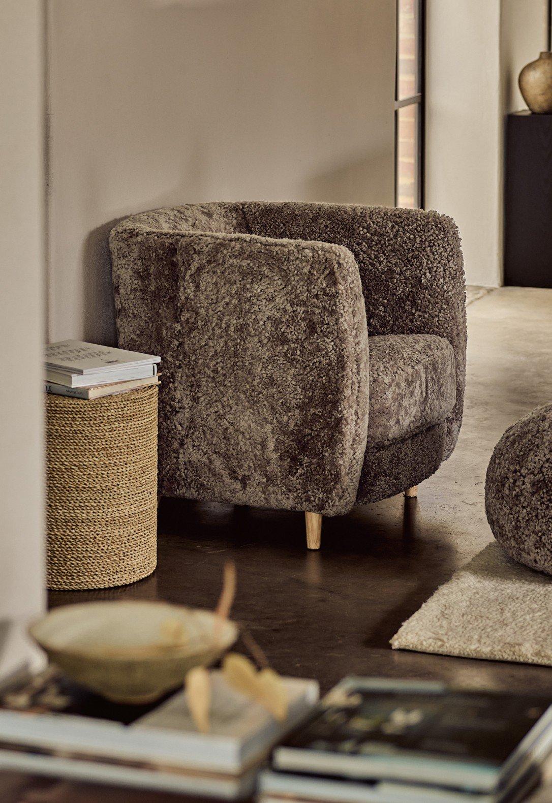 a living room with a couch and ottoman in a room