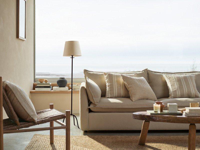 a living room with a couch, coffee table, and lamp