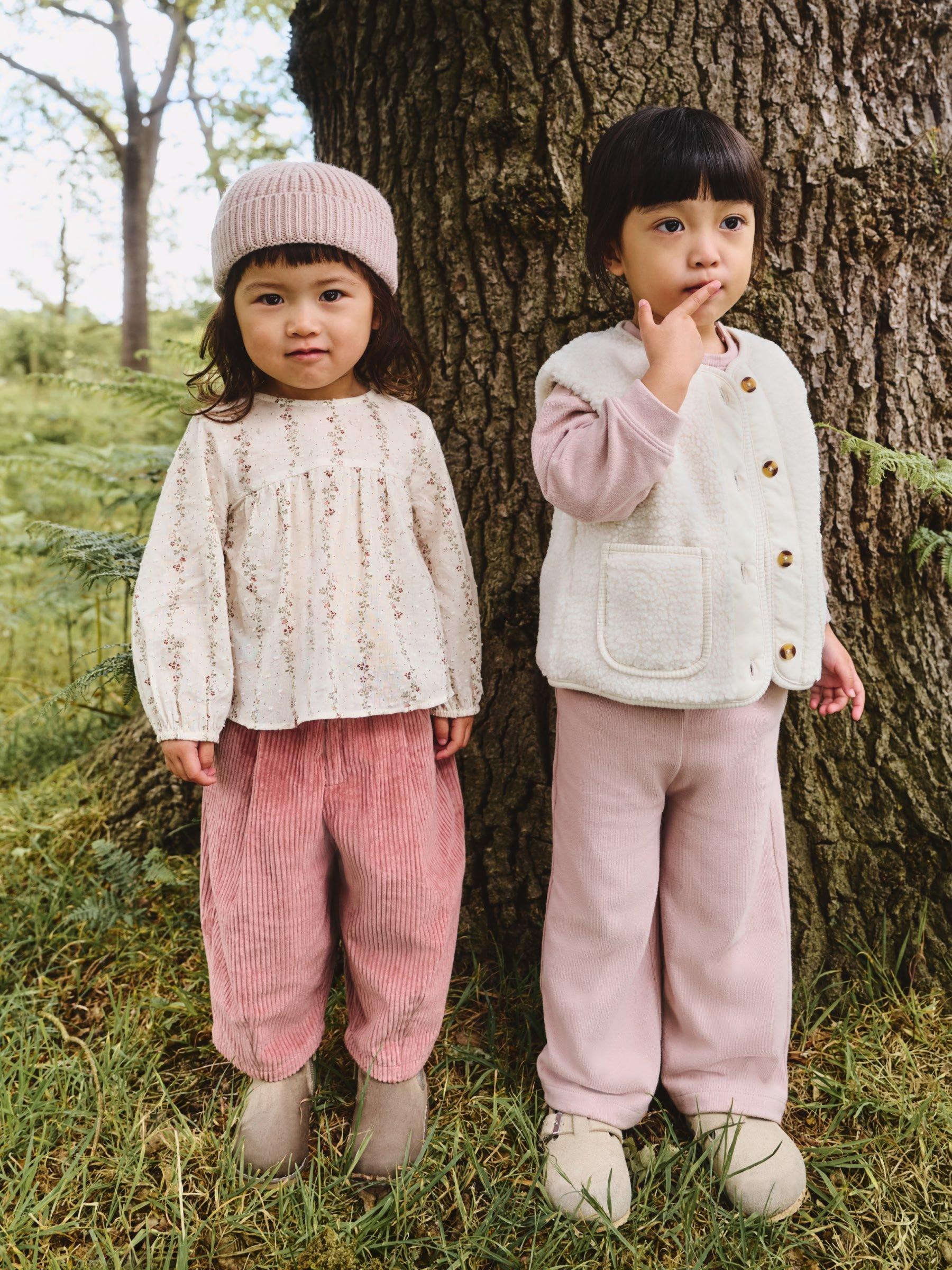 girls in the woods in pink outfits