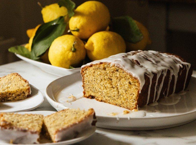a loaf of cake on a plate with a slice cut out