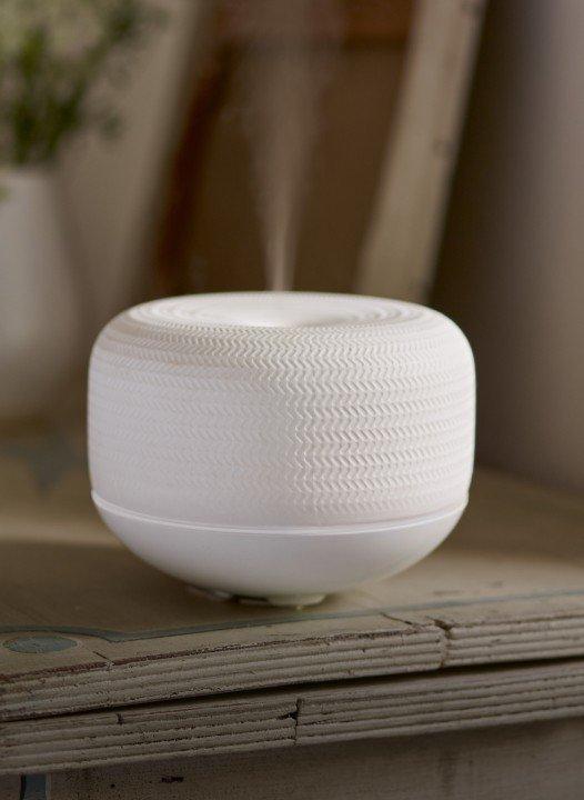 a white bowl with a steam coming out of it on a table