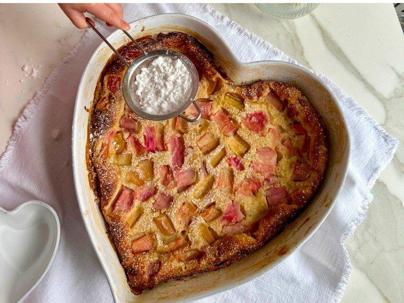 a heart shaped dish with a spoon in it and a heart shaped spoon