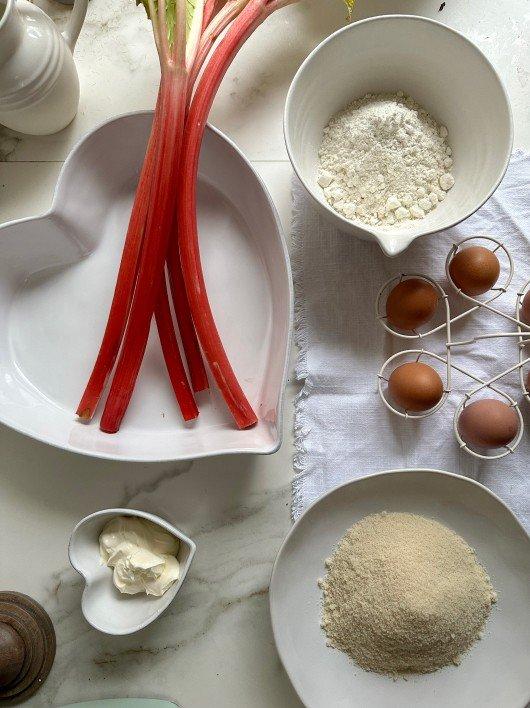 a table with a variety of ingredients for a cake