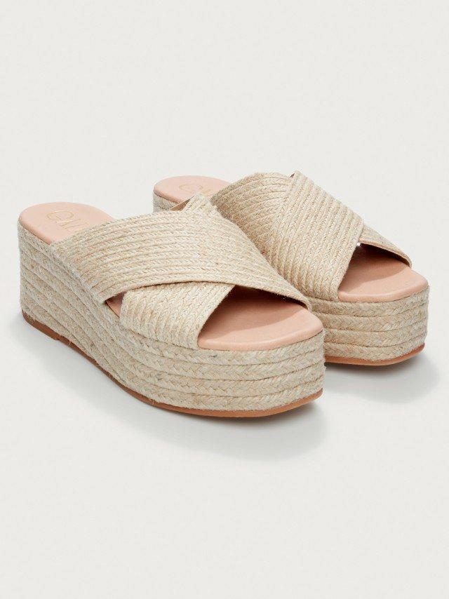 the sandals are made from woven rope and have a platform and a strap