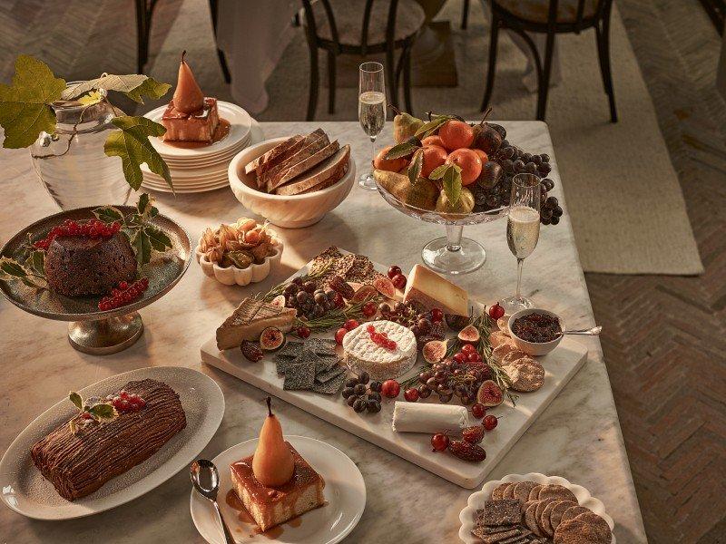 a table topped with plates of food and wine glasses