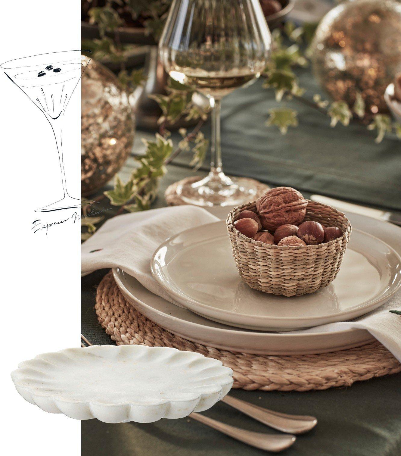 a table setting with a bowl of nuts and a martini glass