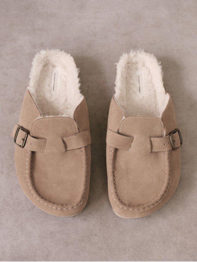 a pair of tan slippers with fur on the bottom
