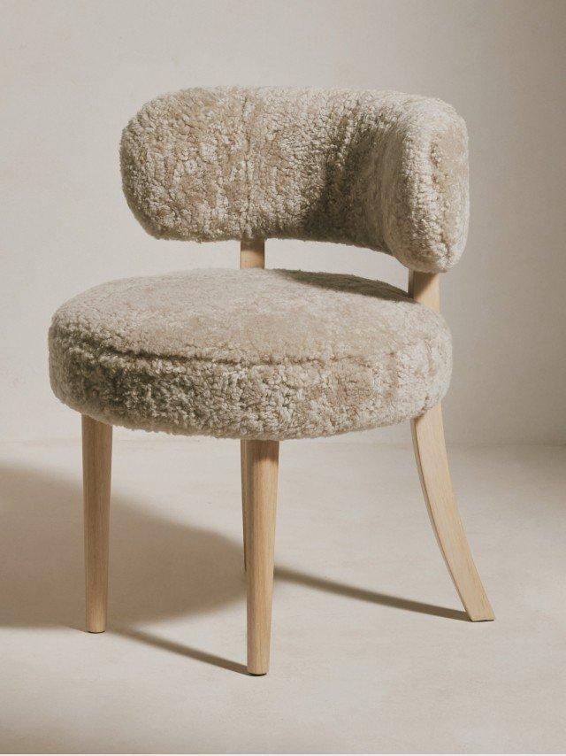 a chair with a furry seat and back on a white floor