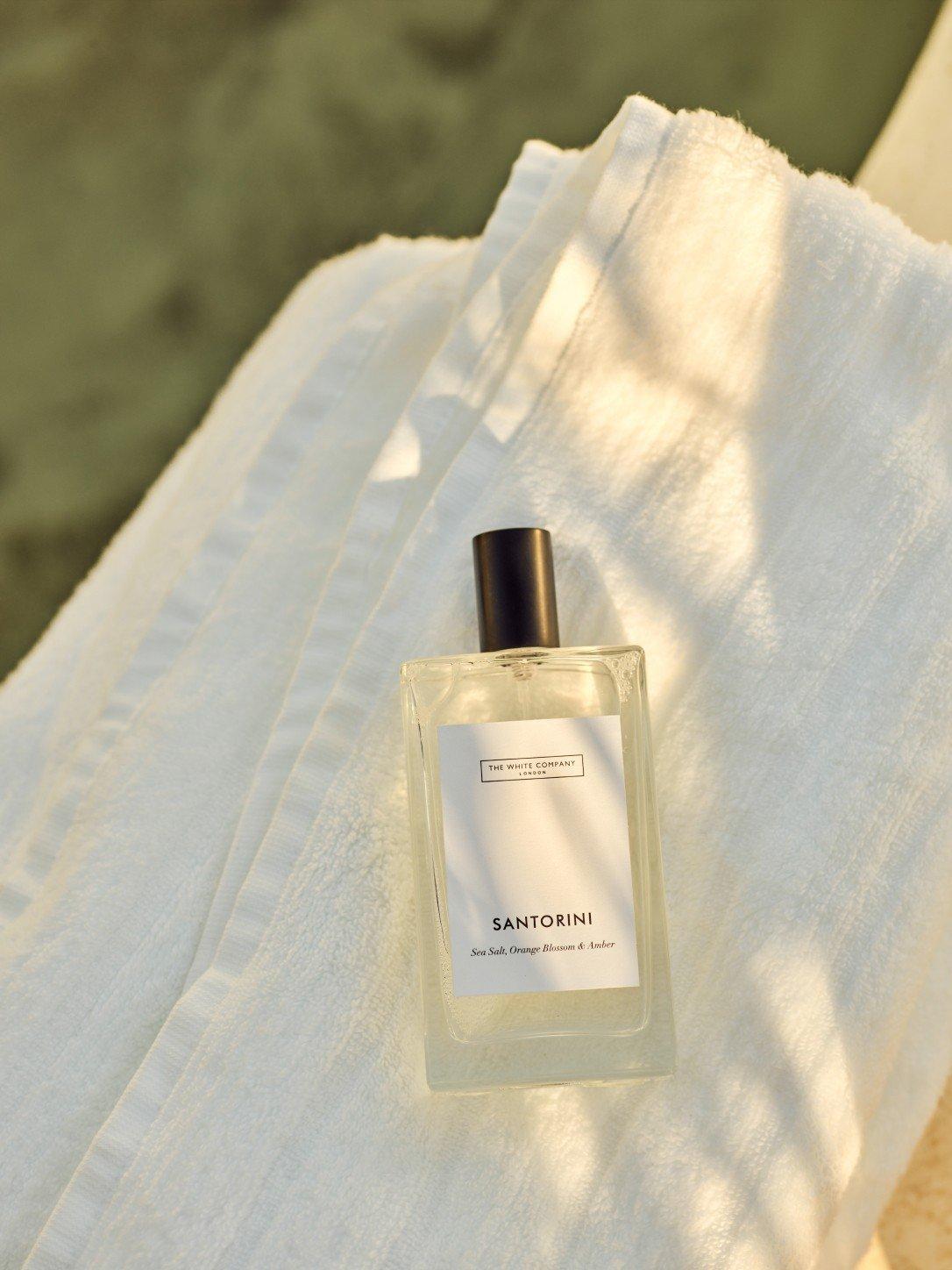 a bottle of perfume sitting on top of a towel