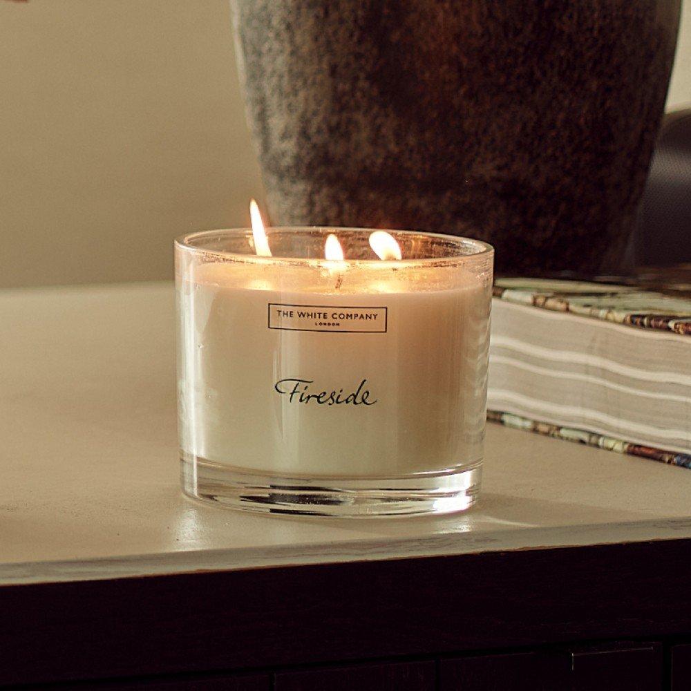 a candle next to a box of lavender and flowers