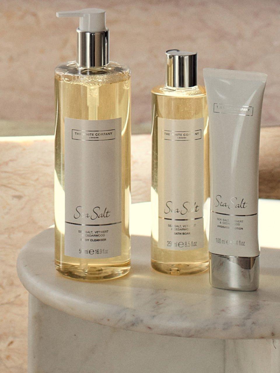 a couple of bottles of lotion and soap sitting on a marble table