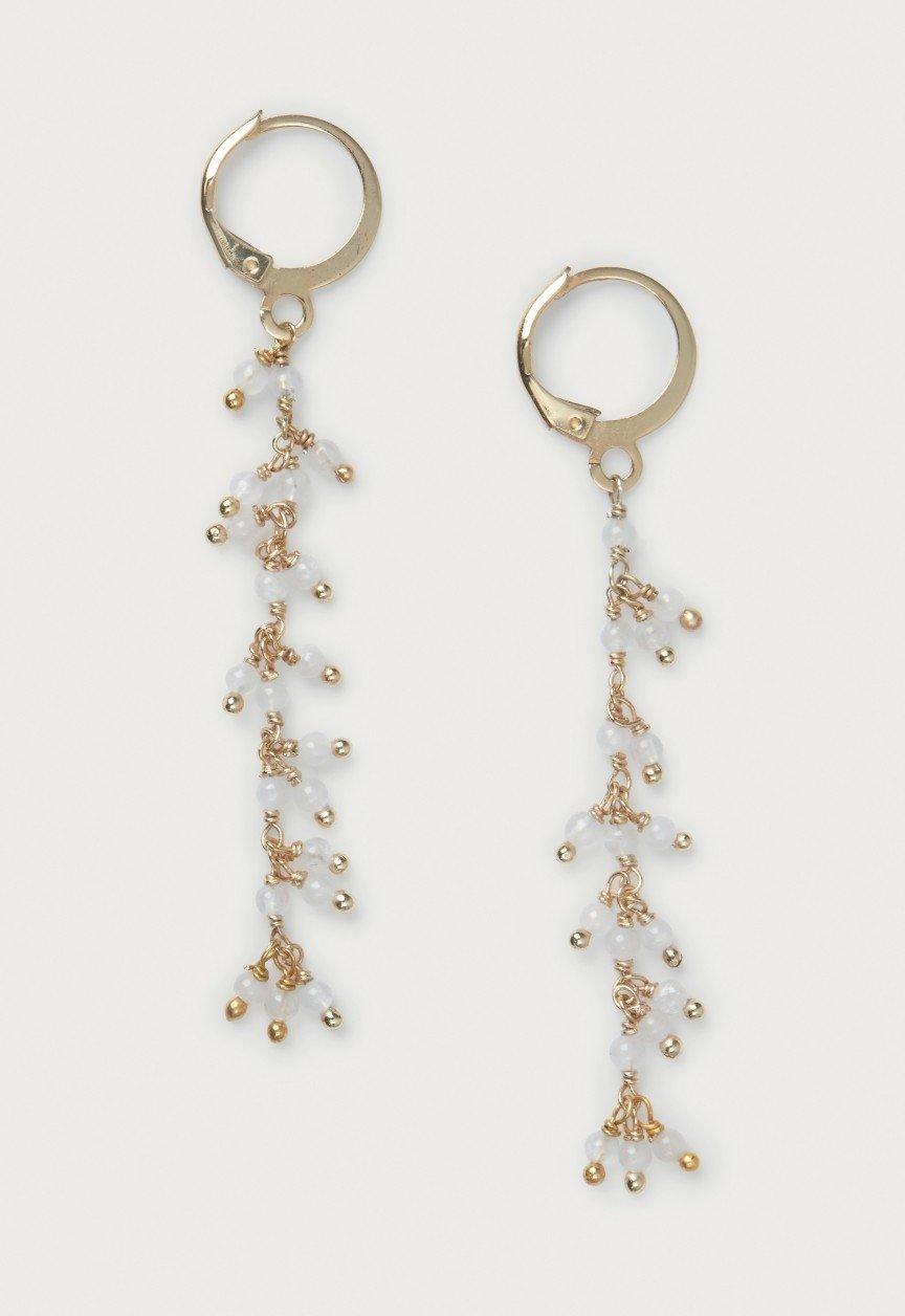 two gold - plated hoop earrings with white beads