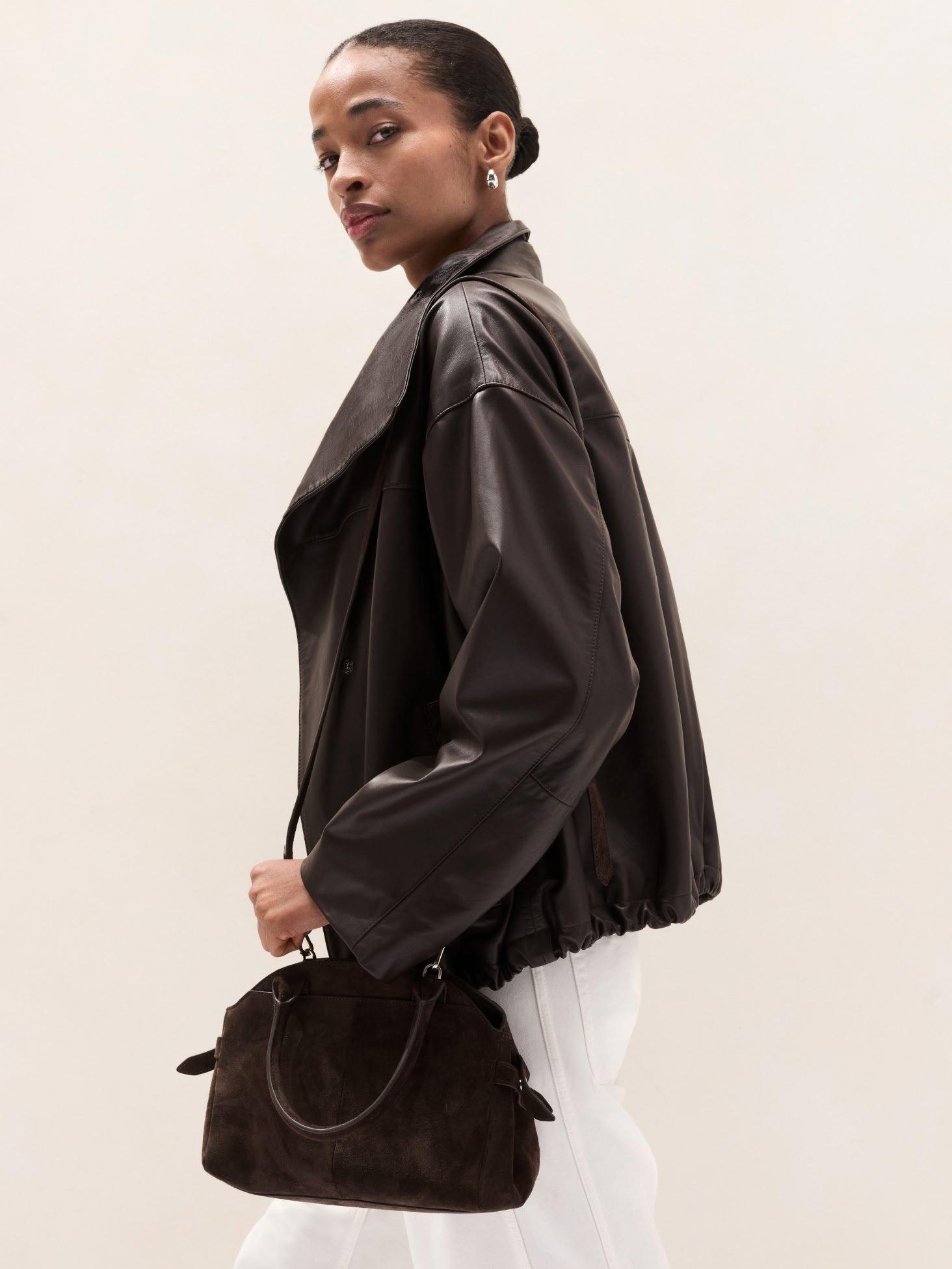 woman in leather funnel neck bomber jacket