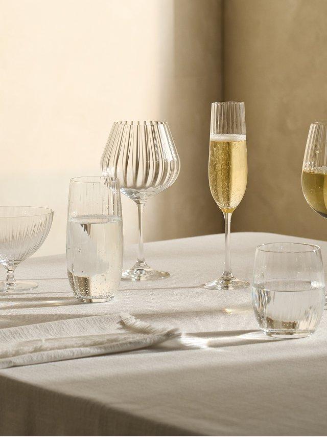 a table with several glasses and wine glasses on it