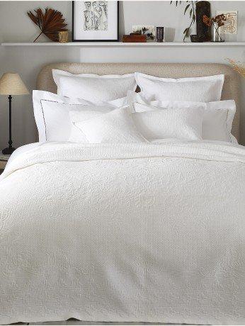 white bedding on a bed