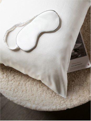 white silk eyemask on a silk pillow