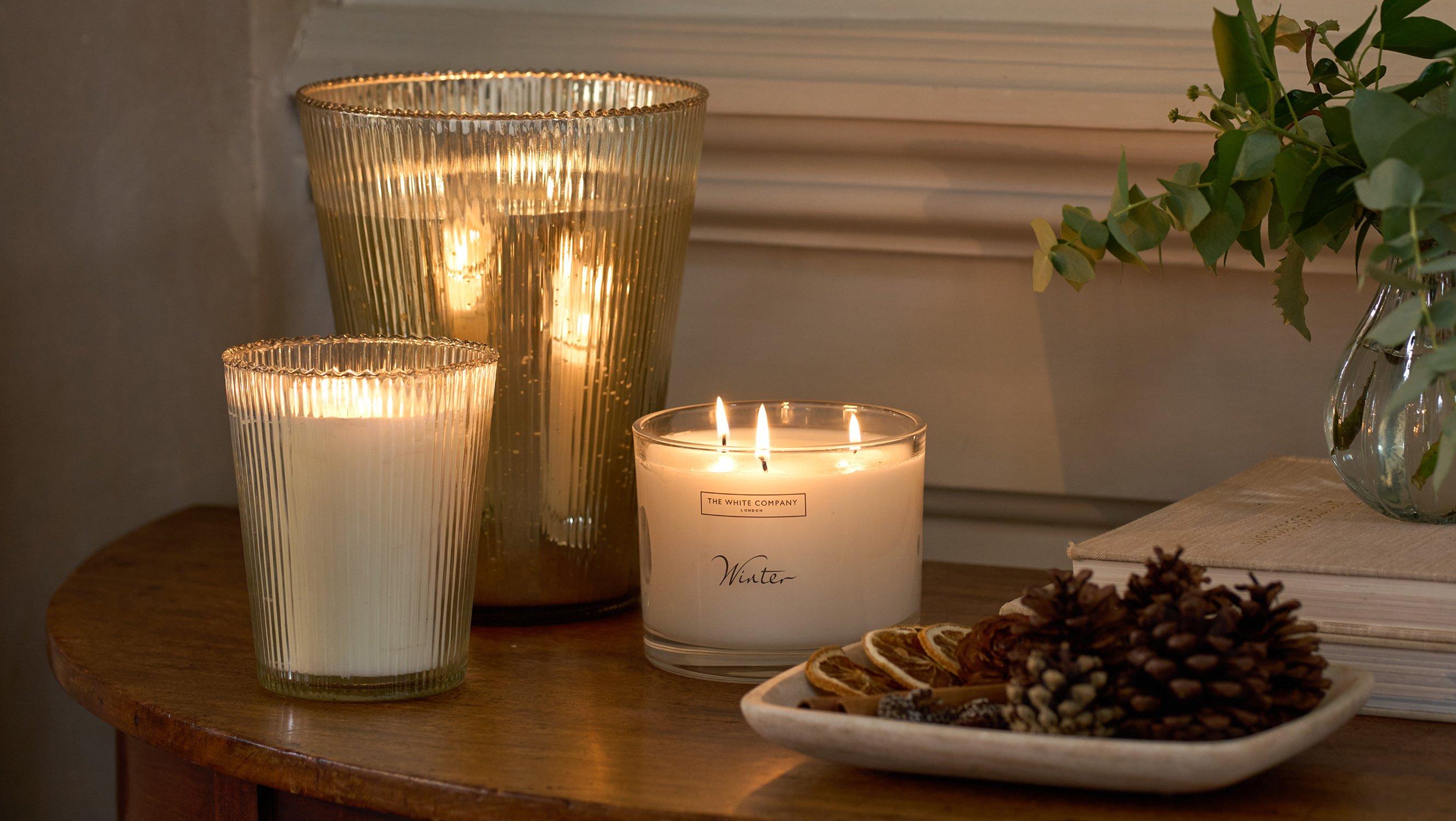 a table with candles and a plant on it with a candle