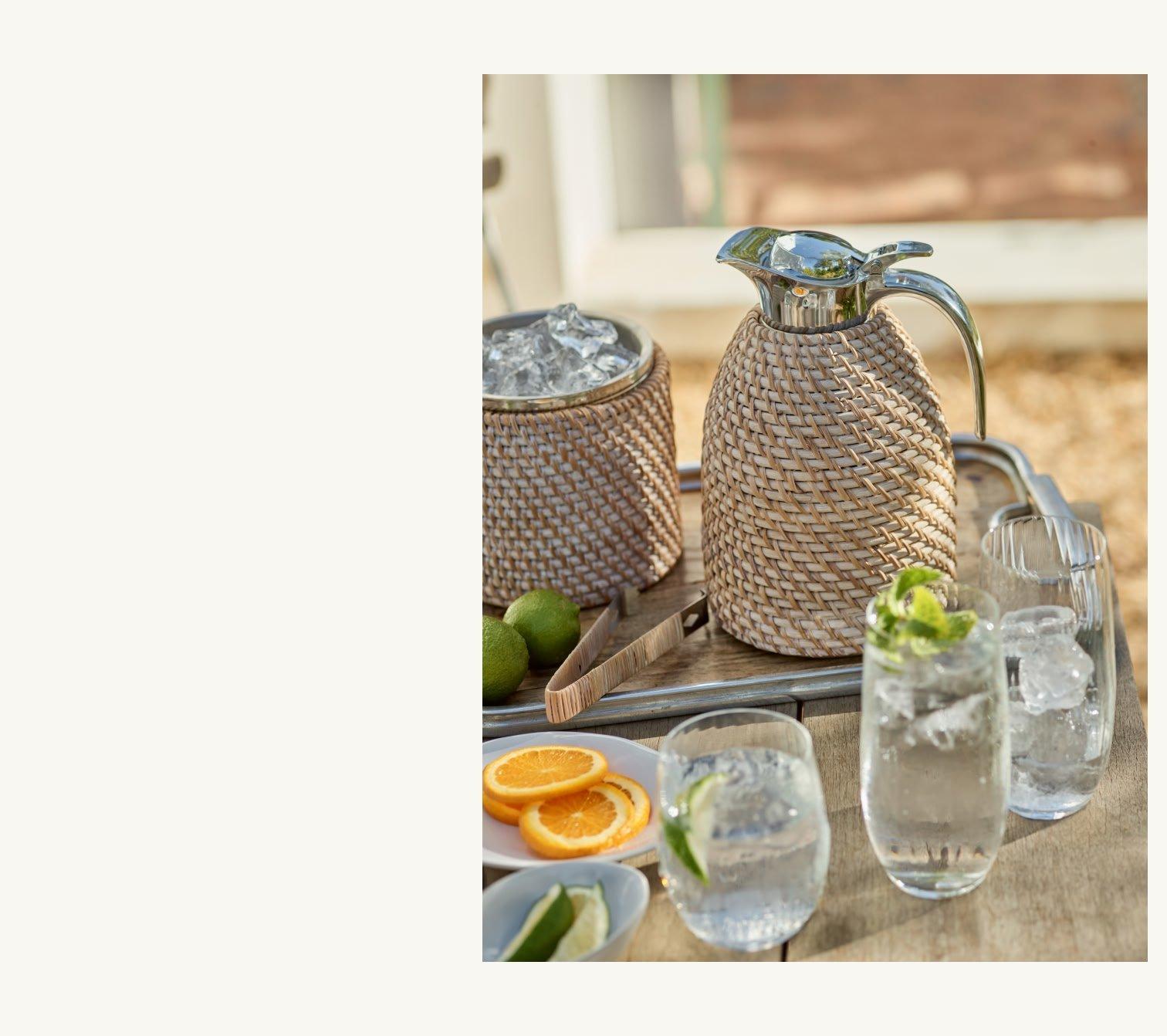 a tray with a pitcher, glasses, and ice on it