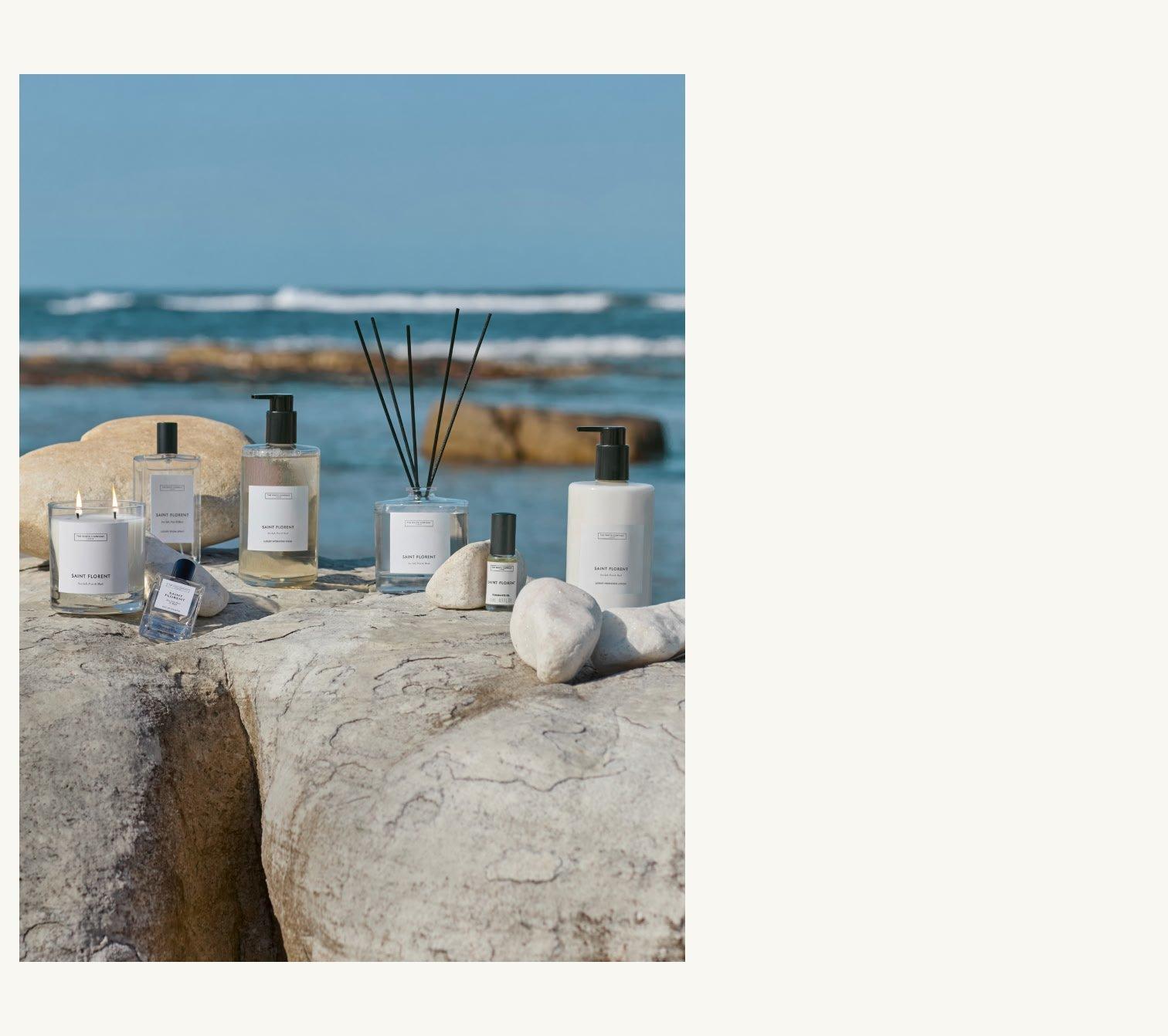 a collection of products on a rock by the ocean